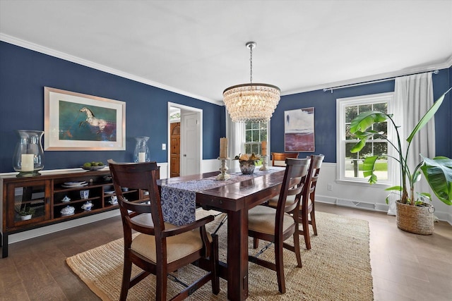 9848 N Lamplighter Ln, Mequon, WI 53092 - dining space featuring a chandelier, crown molding, and wood finished floors