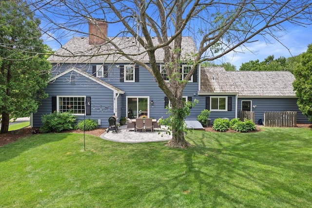 9848 N Lamplighter Ln, Mequon, WI 53092 - rear view of house featuring a chimney, a patio, and a lawn