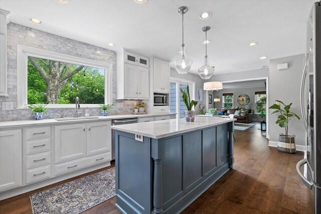 9848 N Lamplighter Ln, Mequon, WI 53092 - kitchen featuring appliances with stainless steel finishes, white cabinets, tasteful backsplash, light countertops, and recessed lighting