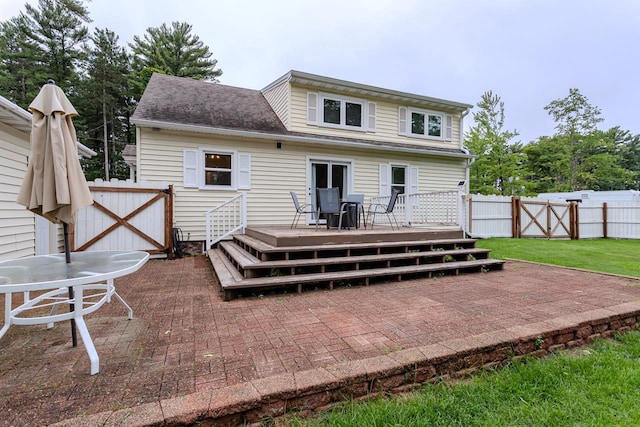 1119 W Grand Ave, Rothschild, WI 54474 - back of property featuring a gate, a wooden deck, a fenced backyard, and a patio