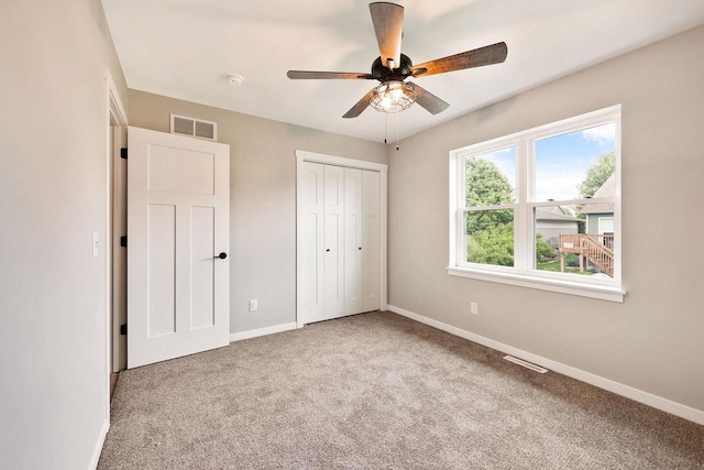 1088 Kamperschroer Way, Sun Prairie, WI 53590 - unfurnished bedroom with carpet, a closet, and a ceiling fan
