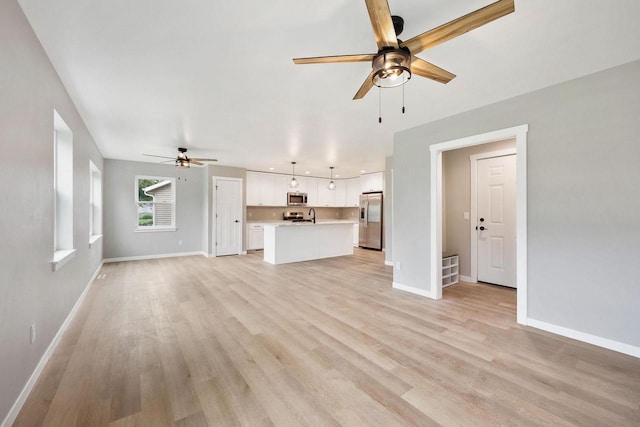 1088 Kamperschroer Way, Sun Prairie, WI 53590 - unfurnished living room featuring ceiling fan and light wood finished floors