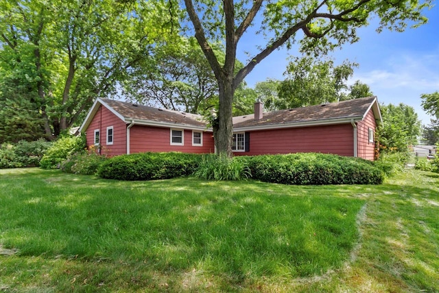 W173N8465 Robert Ave, Menomonee Falls, WI 53051 - view of front of home with a chimney and a front yard