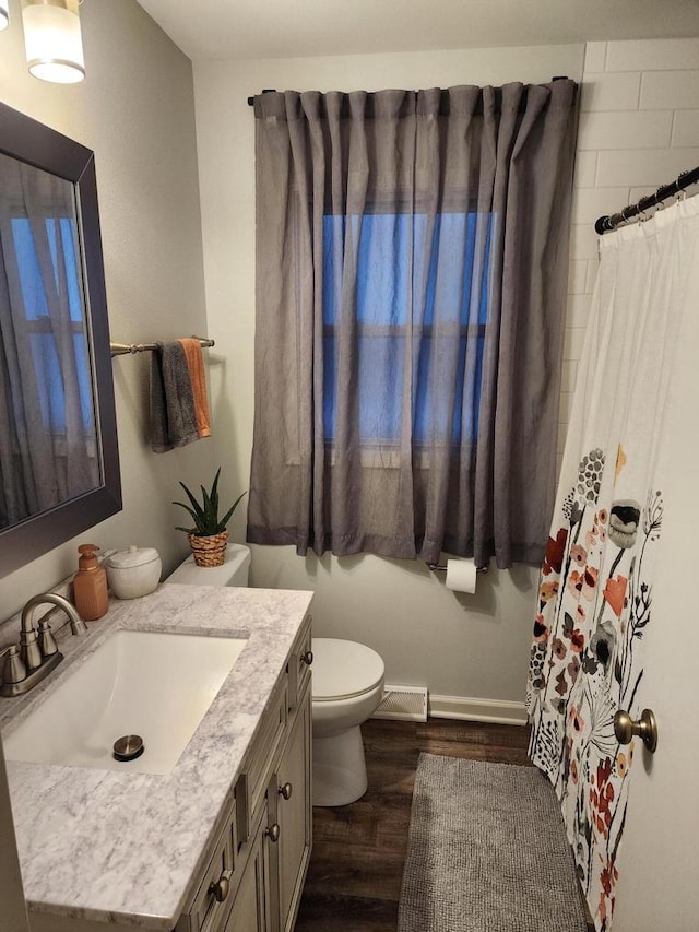 209 S 73rd St, Milwaukee, WI 53214 - full bath featuring wood finished floors, vanity, and a shower with shower curtain