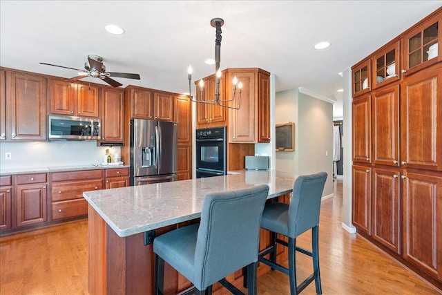 110985 Candlewood Ct, Marshfield, WI 54449 - kitchen with appliances with stainless steel finishes, a kitchen bar, light wood-type flooring, glass insert cabinets, and recessed lighting