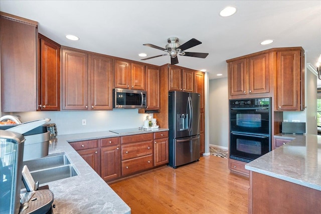 110985 Candlewood Ct, Marshfield, WI 54449 - kitchen featuring black appliances, recessed lighting, a ceiling fan, light wood-style flooring, and light stone countertops