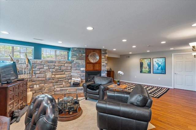 110985 Candlewood Ct, Marshfield, WI 54449 - living area with recessed lighting, wood finished floors, a fireplace, and a textured ceiling