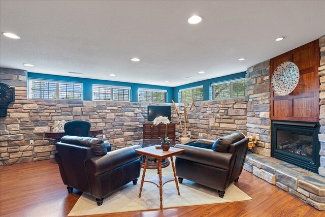 110985 Candlewood Ct, Marshfield, WI 54449 - living room featuring wood finished floors, recessed lighting, and a stone fireplace