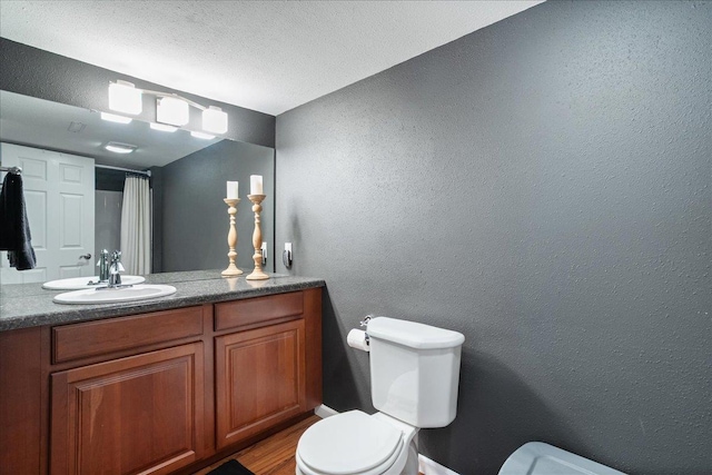 110985 Candlewood Ct, Marshfield, WI 54449 - full bath featuring vanity, a textured wall, wood finished floors, and a shower with curtain