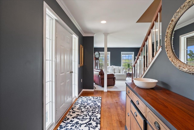 110985 Candlewood Ct, Marshfield, WI 54449 - entrance foyer featuring ornate columns, light wood-type flooring, crown molding, and stairs