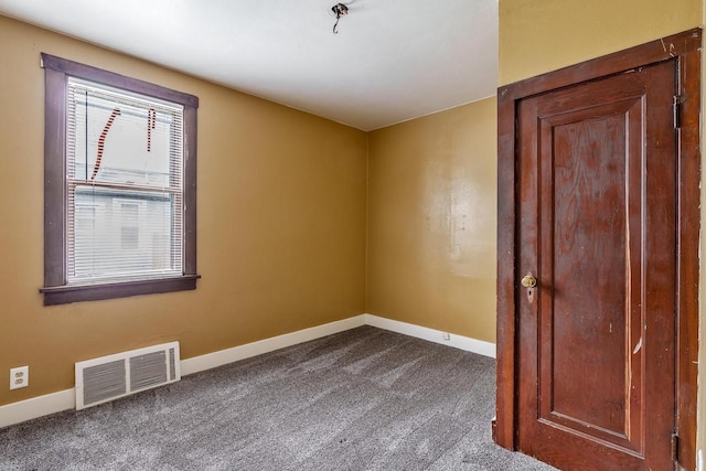 1015 Bluff St, Beloit, WI 53511 - empty room with dark carpet and baseboards