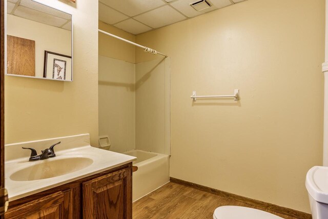 1015 Bluff St, Beloit, WI 53511 - full bath featuring wood finished floors, shower / bathtub combination, vanity, and a paneled ceiling