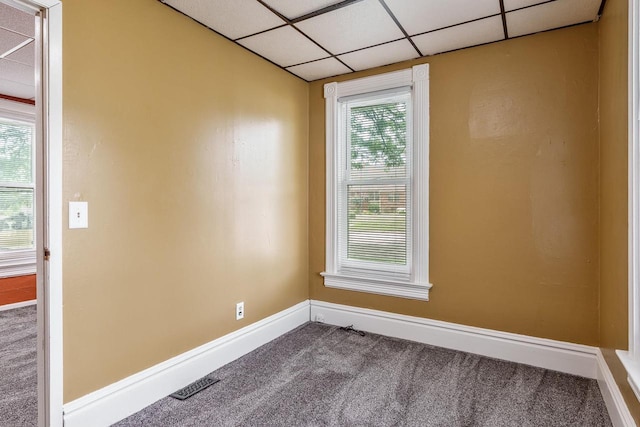 1015 Bluff St, Beloit, WI 53511 - carpeted empty room with a drop ceiling and baseboards