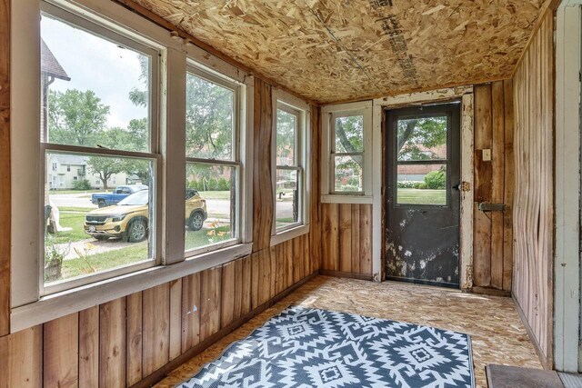 1015 Bluff St, Beloit, WI 53511 - unfurnished sunroom with wood walls and baseboards