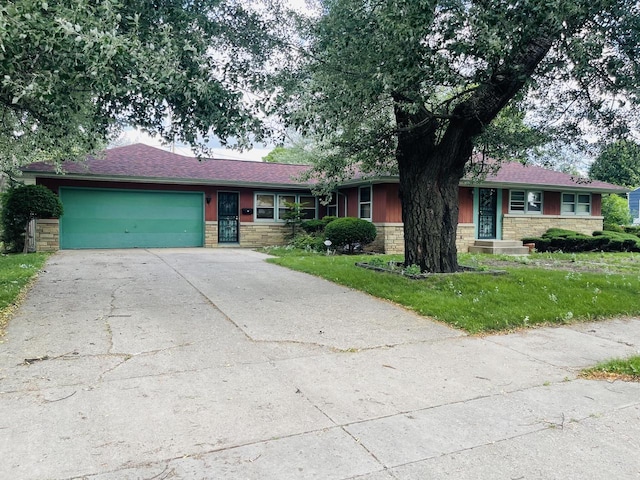 5734 N 80th St, Milwaukee, WI 53218 - single story home with an attached garage, driveway, stone siding, and a front yard