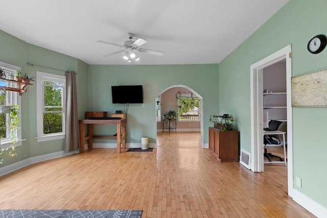 731 S Michigan St, De Pere, WI 54115 - living room featuring wood-type flooring, arched walkways, plenty of natural light, and ceiling fan