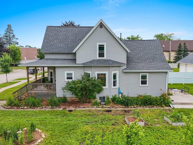731 S Michigan St, De Pere, WI 54115 - rear view of house featuring a shingled roof, a garden, a patio area, and covered porch
