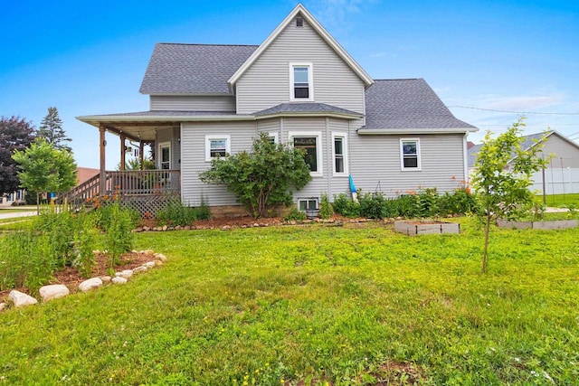 731 S Michigan St, De Pere, WI 54115 - rear view of property featuring a lawn, a porch, and a shingled roof