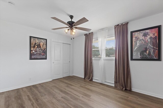 8122 W Potomac Ave, Milwaukee, WI 53218 - unfurnished bedroom featuring wood finished floors, a closet, and a ceiling fan