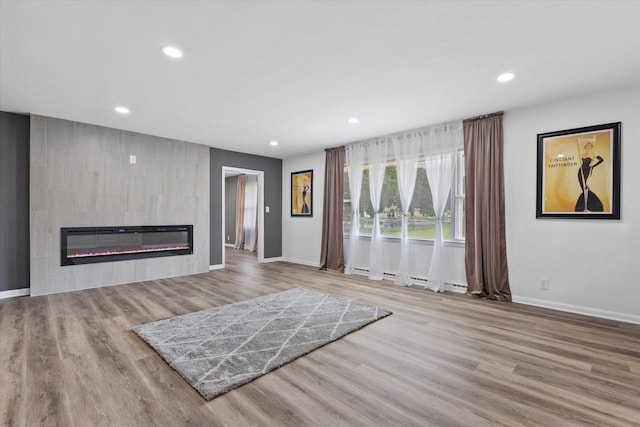 8122 W Potomac Ave, Milwaukee, WI 53218 - unfurnished living room with wood finished floors, a fireplace, and recessed lighting