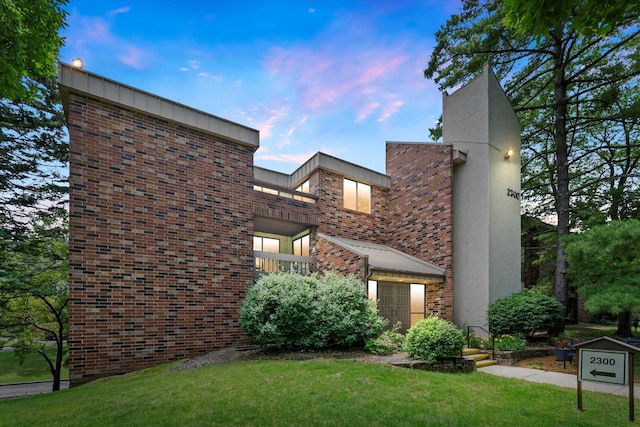 2300 W Good Hope Rd Unit 242, Glendale, WI 53209 - view of front of home featuring brick siding and a yard