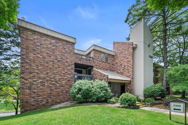 2300 W Good Hope Rd Unit 242, Glendale, WI 53209 - view of front of house with brick siding, a front lawn, and a chimney