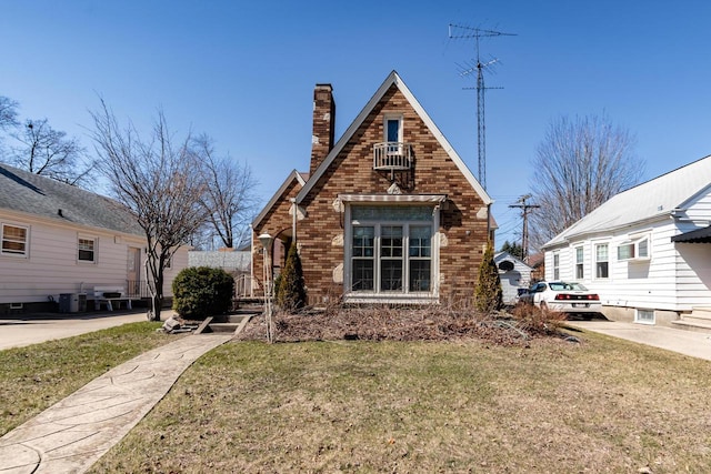 7414 5th Ave, Kenosha, WI 53143 - view of front of house with a front lawn, a chimney, and brick siding