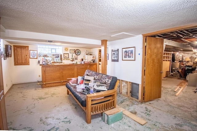 7414 5th Ave, Kenosha, WI 53143 - living area with concrete flooring and a textured ceiling