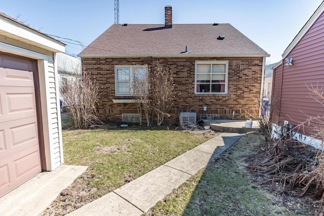 7414 5th Ave, Kenosha, WI 53143 - back of house featuring a lawn, brick siding, a chimney, and a shingled roof