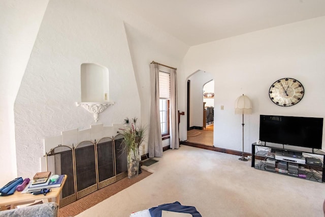 7414 5th Ave, Kenosha, WI 53143 - living area featuring arched walkways, carpet flooring, and lofted ceiling