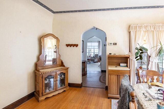 7414 5th Ave, Kenosha, WI 53143 - corridor with arched walkways, light wood finished floors, and crown molding