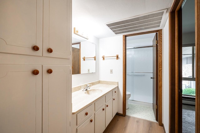 11957 N Appleton Ave Unit 19, Milwaukee, WI 53224 - full bathroom featuring vanity, an enclosed shower, and wood finished floors