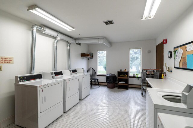 11957 N Appleton Ave Unit 19, Milwaukee, WI 53224 - community laundry room with washer and clothes dryer and light tile patterned flooring