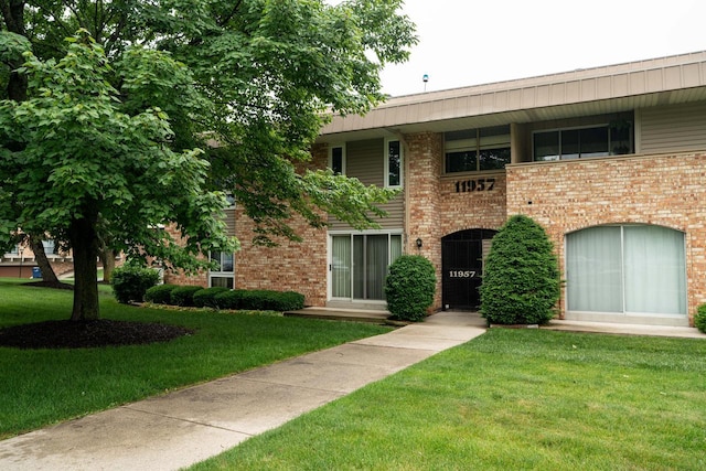 11957 N Appleton Ave Unit 19, Milwaukee, WI 53224 - view of front of house with a front yard and brick siding