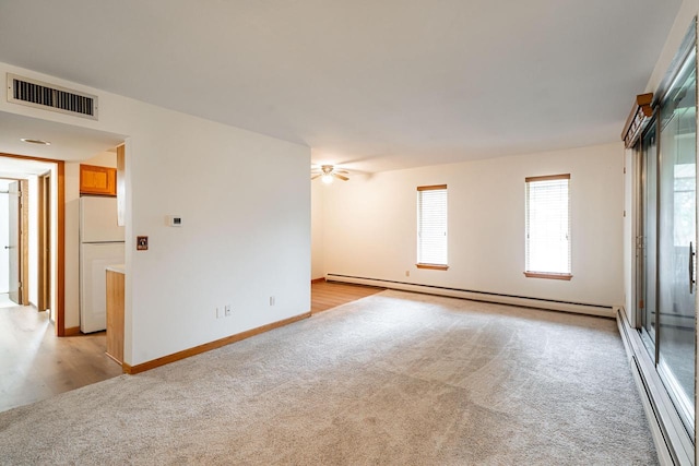 11957 N Appleton Ave Unit 19, Milwaukee, WI 53224 - unfurnished room featuring light carpet, a baseboard heating unit, healthy amount of natural light, and ceiling fan