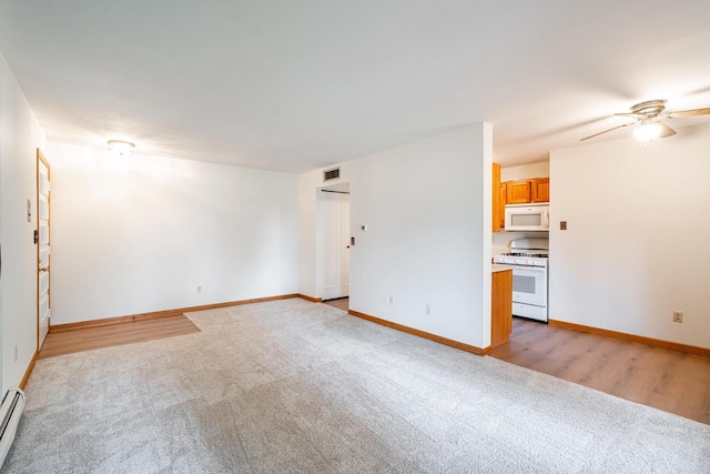 11957 N Appleton Ave Unit 19, Milwaukee, WI 53224 - unfurnished living room featuring light carpet, a ceiling fan, and a baseboard heating unit