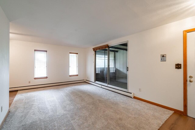 11957 N Appleton Ave Unit 19, Milwaukee, WI 53224 - empty room featuring a baseboard radiator and carpet floors