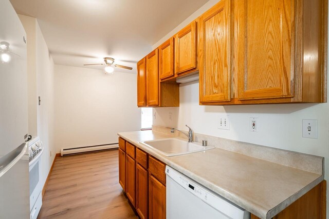11957 N Appleton Ave Unit 19, Milwaukee, WI 53224 - kitchen with white appliances, baseboard heating, ceiling fan, light wood finished floors, and brown cabinetry