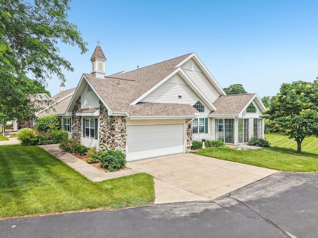 5682 Steeplechase Dr, Waunakee, WI 53597 - view of front of property featuring an attached garage, roof with shingles, a front yard, concrete driveway, and stone siding