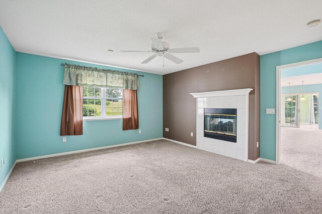 5682 Steeplechase Dr, Waunakee, WI 53597 - unfurnished living room featuring carpet flooring, a ceiling fan, and a fireplace