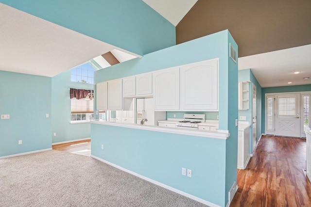 5682 Steeplechase Dr, Waunakee, WI 53597 - kitchen with white appliances, high vaulted ceiling, white cabinetry, and light countertops
