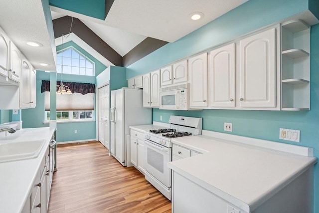 5682 Steeplechase Dr, Waunakee, WI 53597 - kitchen featuring white appliances, white cabinets, light wood-style floors, light countertops, and vaulted ceiling