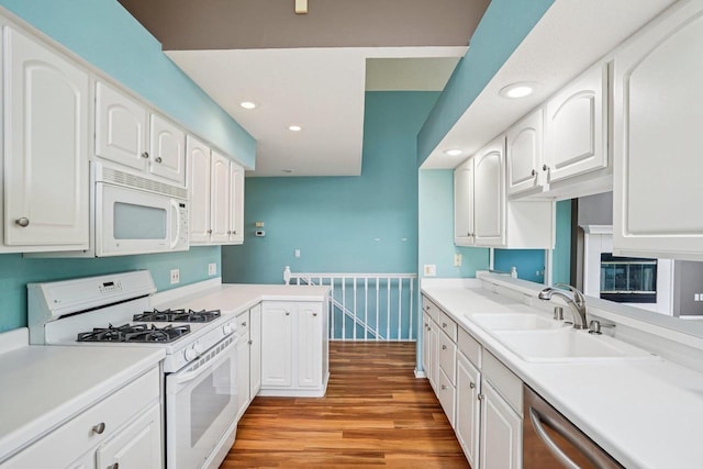 5682 Steeplechase Dr, Waunakee, WI 53597 - kitchen with white appliances, light wood-style flooring, white cabinets, wainscoting, and recessed lighting