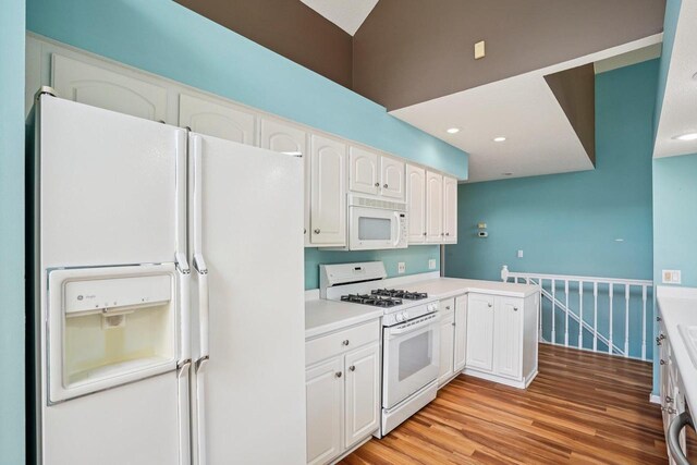 5682 Steeplechase Dr, Waunakee, WI 53597 - kitchen featuring white appliances, white cabinets, light wood-type flooring, light countertops, and recessed lighting