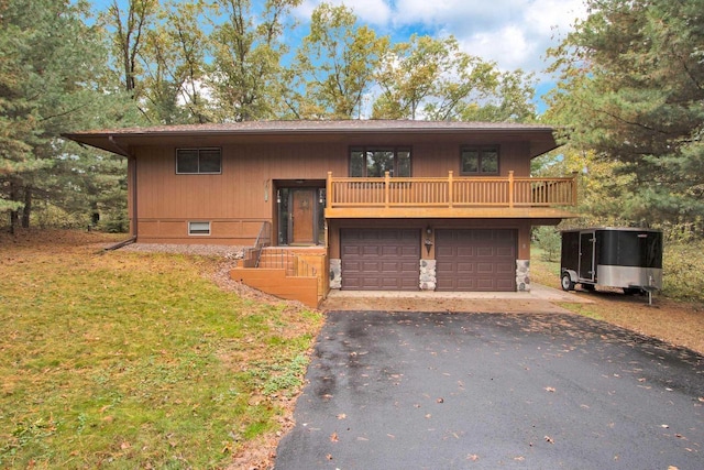 1167 Tee Trl, Nekoosa, WI 54457 - view of front of property featuring driveway, a garage, a front lawn, and stone siding