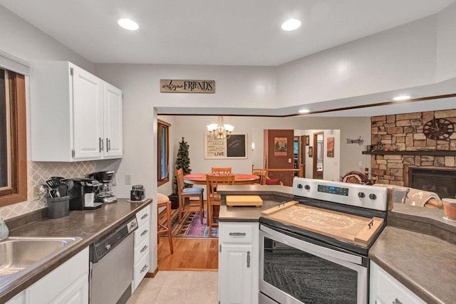 1167 Tee Trl, Nekoosa, WI 54457 - kitchen with appliances with stainless steel finishes, dark countertops, white cabinets, recessed lighting, and a chandelier