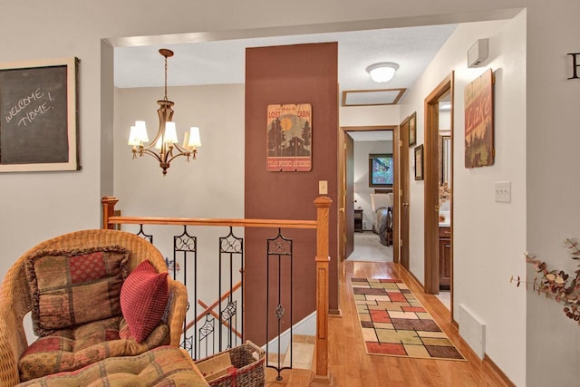 1167 Tee Trl, Nekoosa, WI 54457 - hallway featuring an upstairs landing, light wood-type flooring, and a chandelier