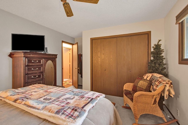 1167 Tee Trl, Nekoosa, WI 54457 - bedroom with carpet flooring, a closet, a ceiling fan, and a textured ceiling
