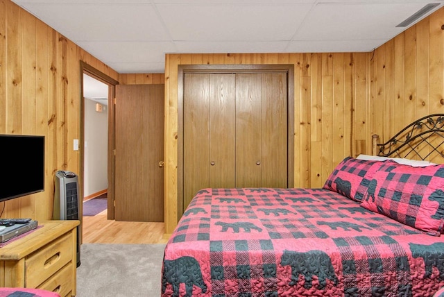 1167 Tee Trl, Nekoosa, WI 54457 - bedroom with wood finished floors, a closet, wooden walls, and a drop ceiling