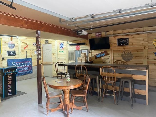 1167 Tee Trl, Nekoosa, WI 54457 - dining area with finished concrete floors and wood walls
